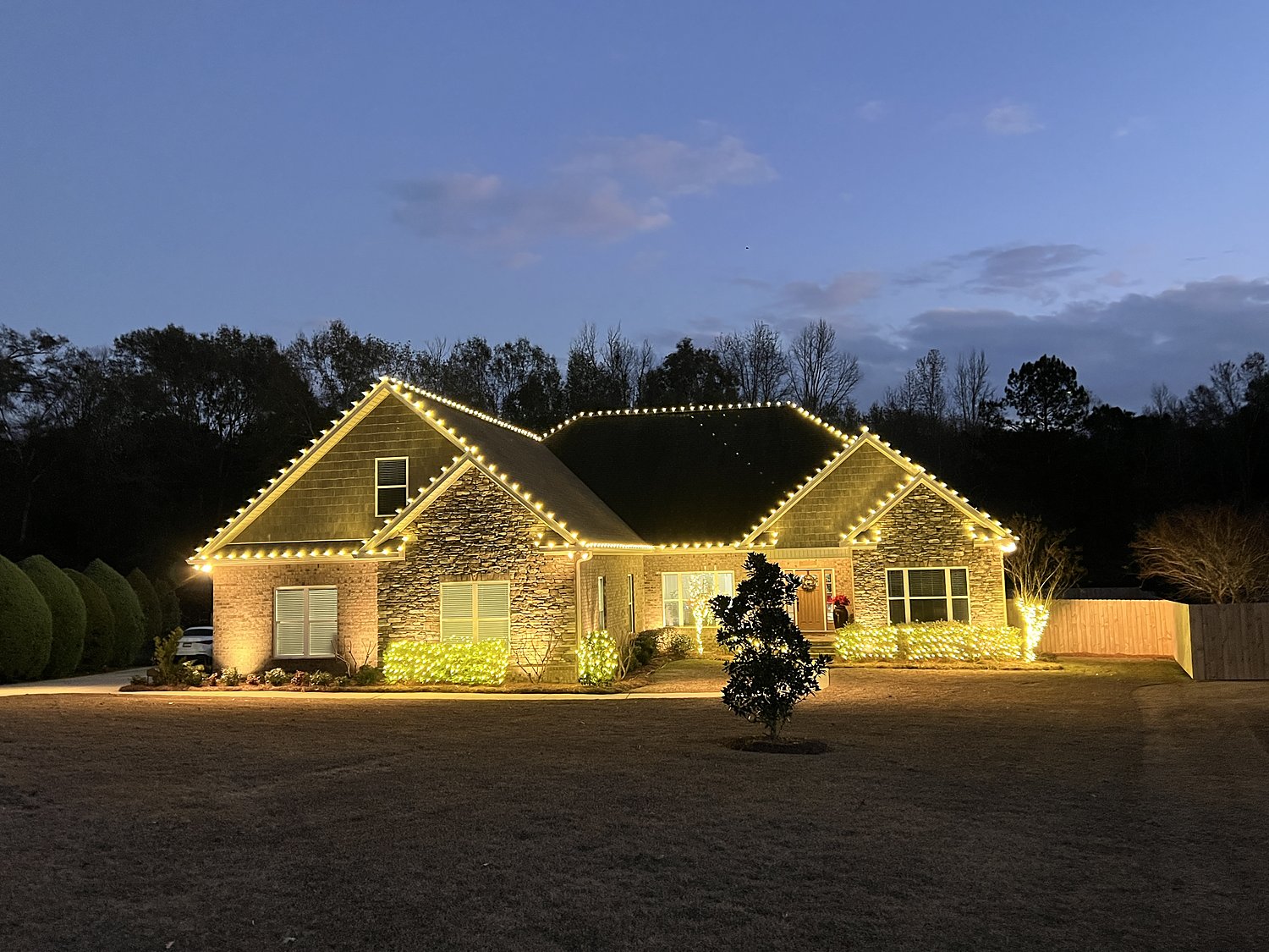 Brick home with warm white roofline lighting