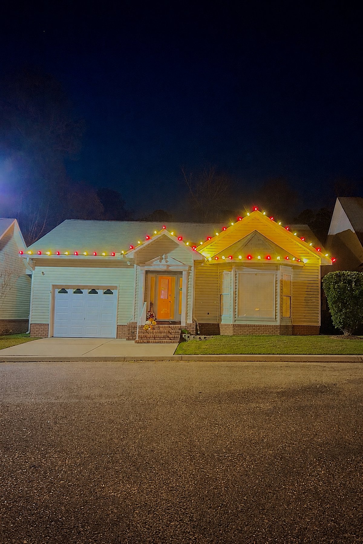 Home with red and warm white C9 roofline lighting