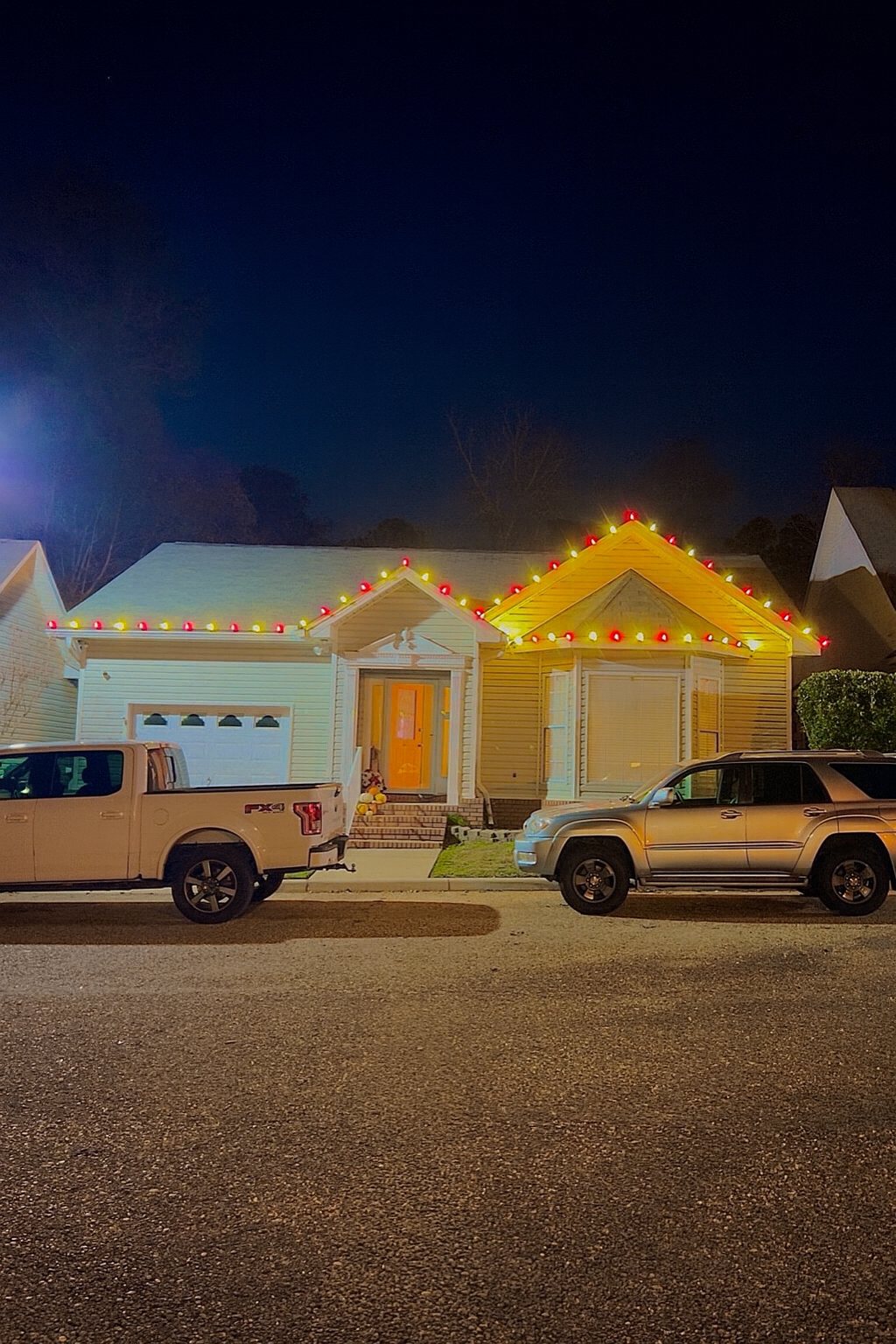 Home with red and warm white C9 lights across both gables