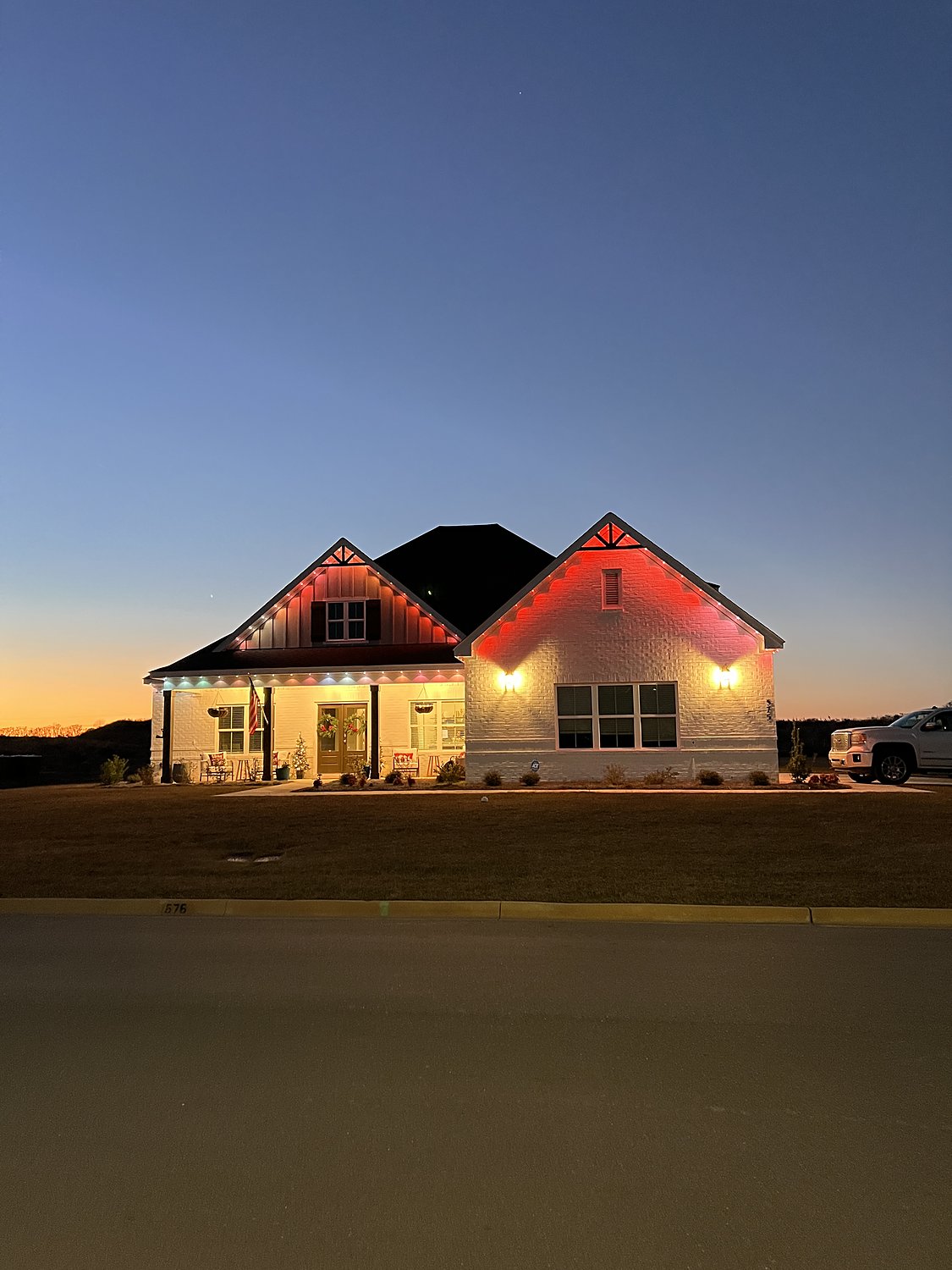 Brick home with red color-changing permanent lighting