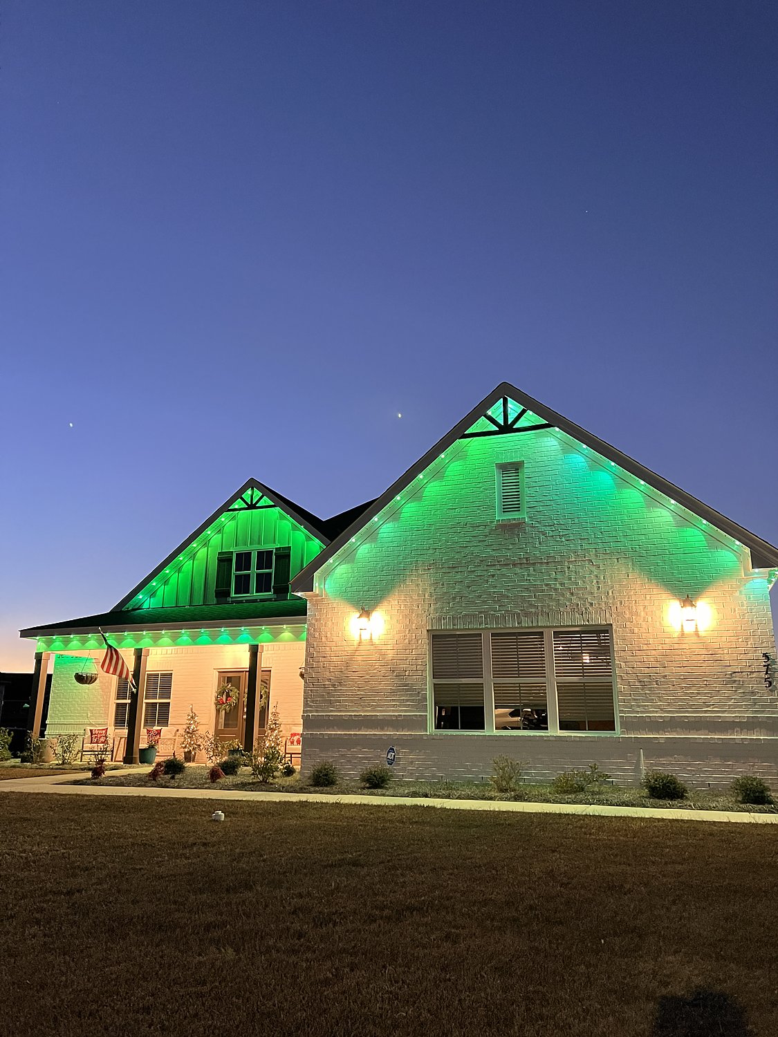 Close view of green color-changing permanent lighting on a gable
