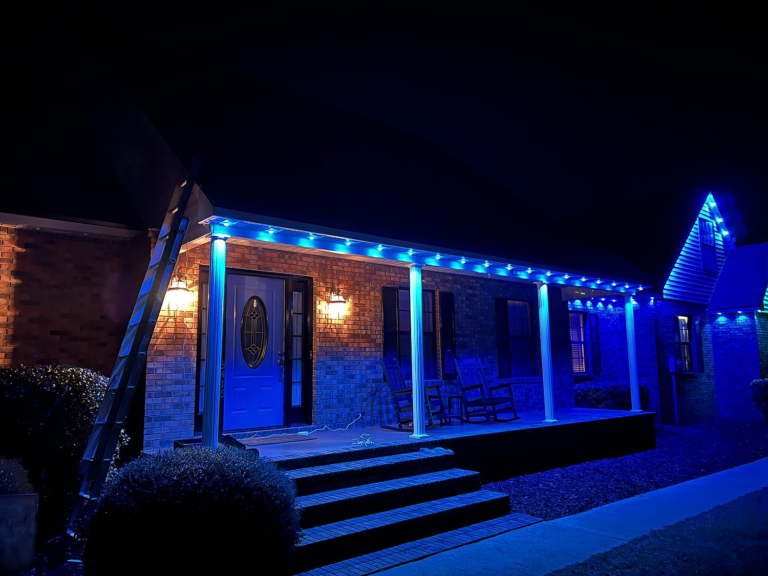 Front porch with blue permanent under-eave lighting